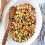 butternut squash quinoa salad with wooden serving spoon