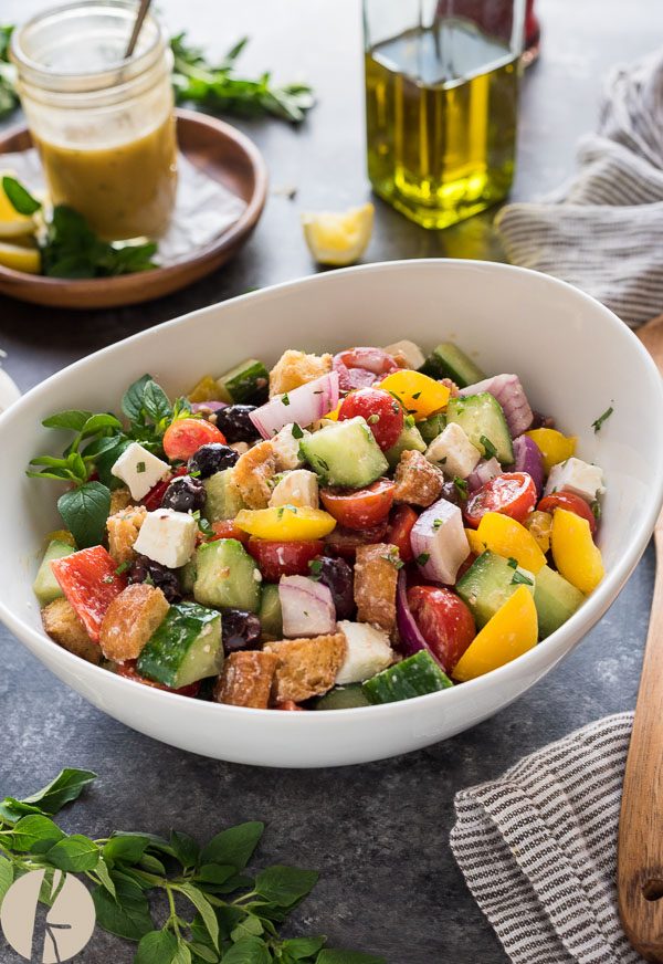 front angled shot of Greek panzanella in white bowl