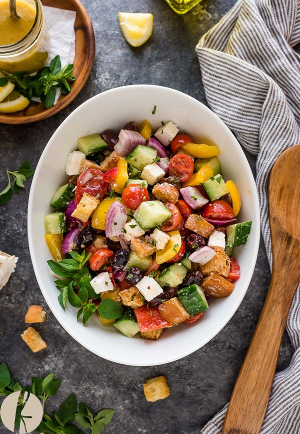 close up overhead shot of Greek panzanella in white bowl