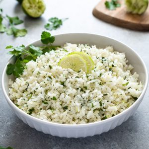 bowl of cilantro lime rice with sliced lime on top