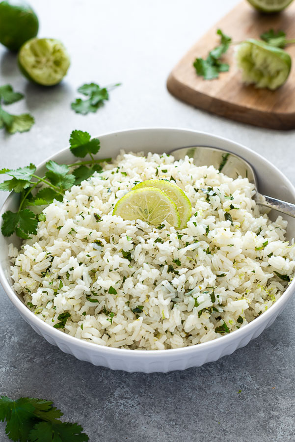 front shot of bowl of cilantro lime rice with cutting board in background