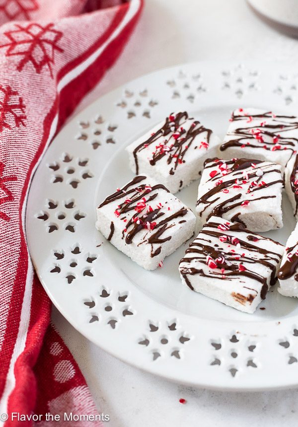 Peppermint marshmallows on a white plate with chocolate on top