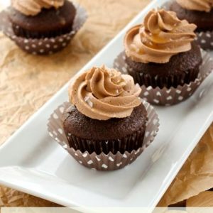 Chocolate cupcakes with salted caramel frosting on a white plate