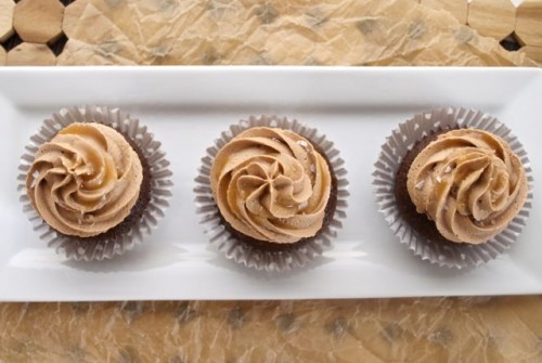 Horizontal shot of chocolate cupcakes on white serving platter