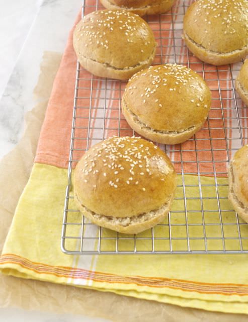 Front shot of whole wheat burger buns on wire rack