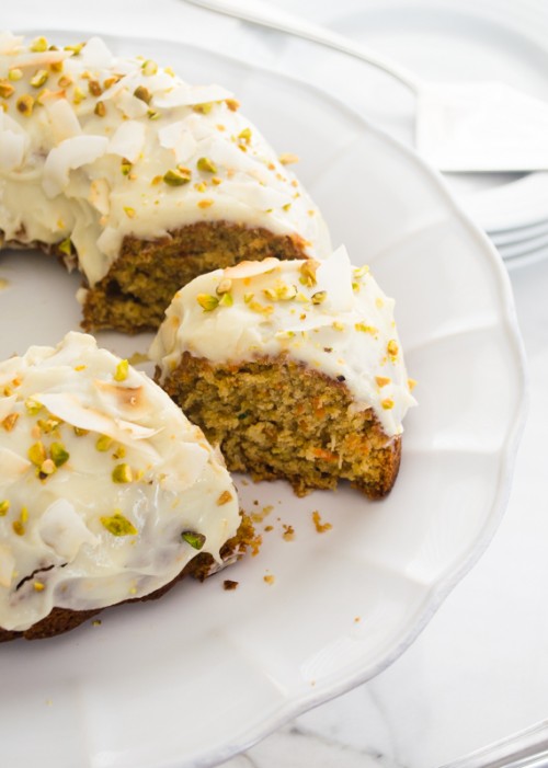 zucchini carrot bundt cake with pistachios and coconut flakes on top