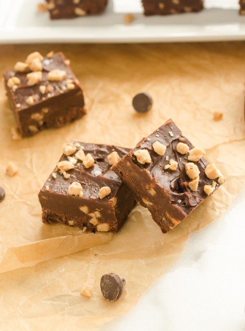 Squares of dark chocolate toffee fudge on parchment paper