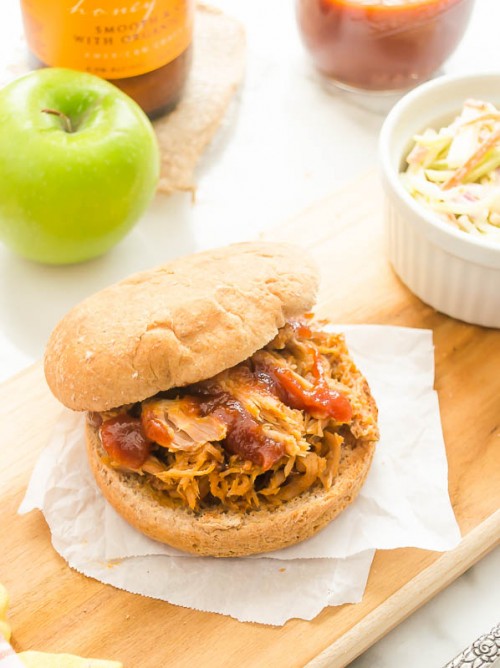 Hard apple cider pulled pork sandwich on cutting board