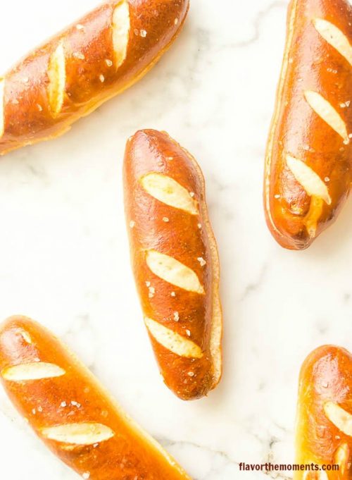 Soft pretzel hot dog buns on marble board