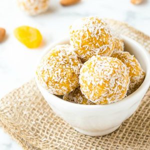 Close up of apricot energy balls in white bowl