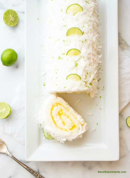 Coconut key lime angel food cake roll on a white platter