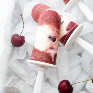 cherry cheesecake greek yogurt pops on bed of ice with cherries