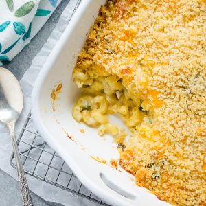 Overhead shot of mac and cheese casserole with serving missing from baking dish