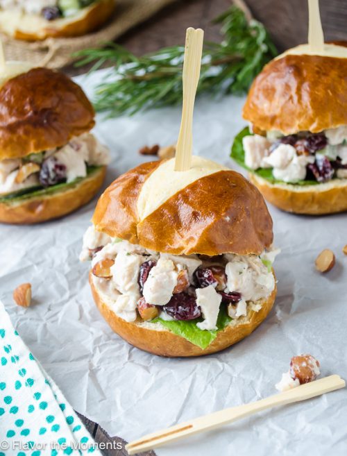 sonoma chicken salad sliders on parchment with rosemary behind