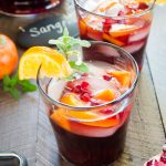 close up front view of red sangria with mint sprig