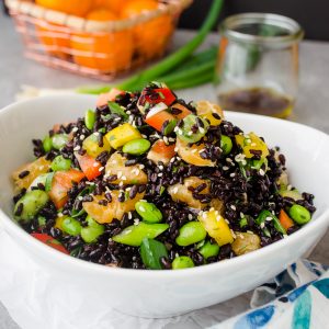 black rice salad pile high in a white bowl
