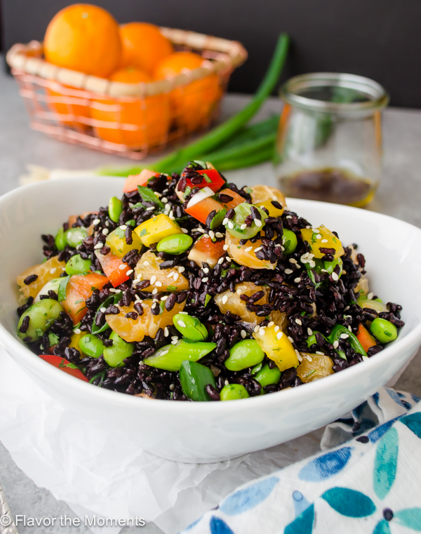 black rice salad pile high in a white bowl