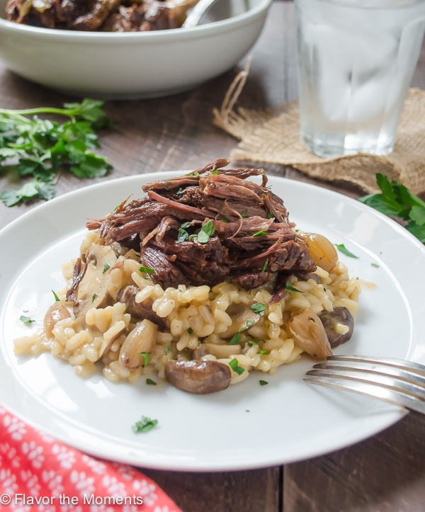 Beef Short Ribs with Mushroom Risotto are beef short ribs cooked in a crock pot until super tender. They're served over creamy mushroom risotto for the ultimate comfort food! @FlavortheMoment