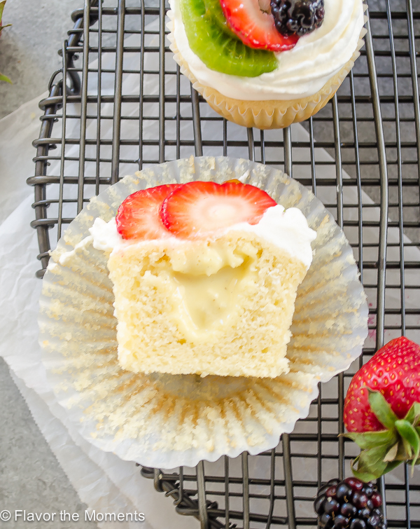 fruit tart vanilla cupcake cut in half to expose pastry cream filling