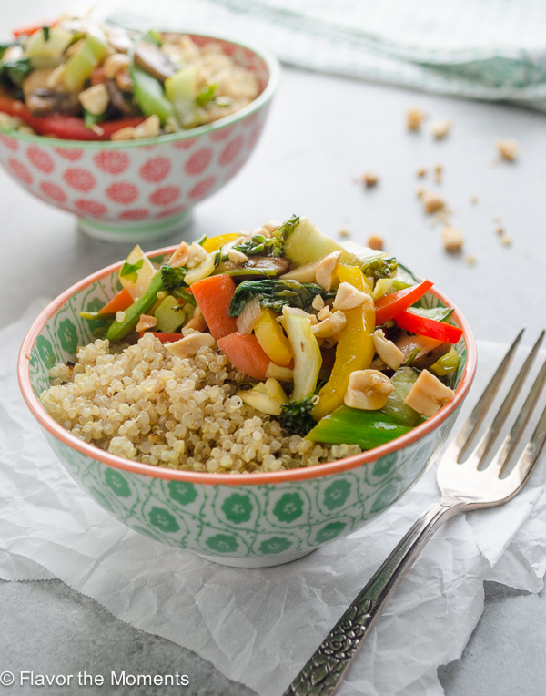Ginger Sesame Veggie Quinoa Bowls are stir-fried veggies with a flavorful ginger sesame sauce. Serve over quinoa and top with chopped peanuts for a hearty vegetarian meal! @FlavortheMoment