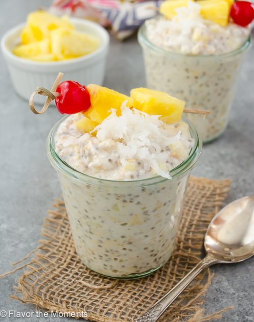 pina colada overnight oats with pineapple and a cherry skewer on top