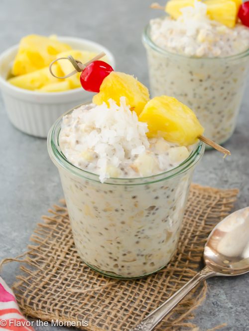 pina colada overnight oats with coconut on top and spoon alongside