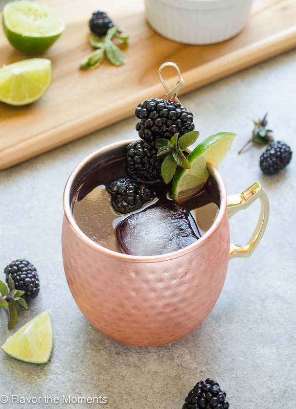 blackberry moscow mule recipe in copper mug with blackberries and lime
