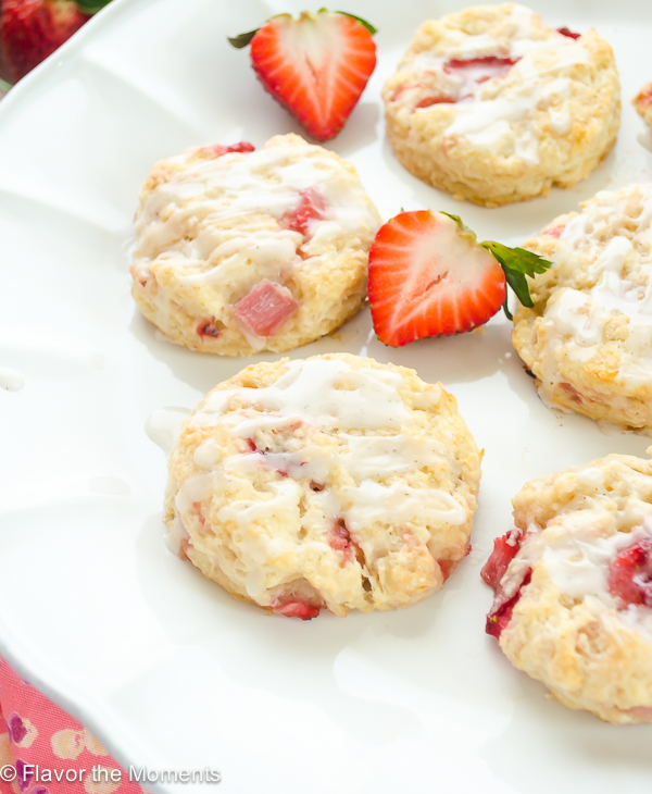 glazed strawberry scones served on cake stand with fresh strawberries