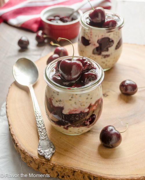 front shot of jar of cherry overnight oats layered with cherry pie filling