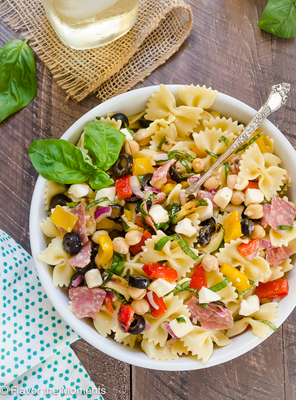 overhead shot of Italian pasta salad in white bowl with basil on top