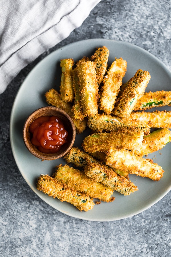 Air fryer zucchini fries on plate with ketchup