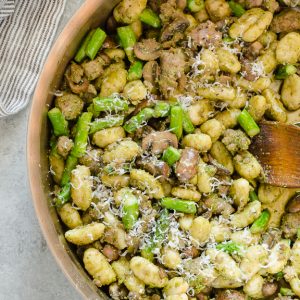 Pesto Gnocchi in skillet with wooden spoon