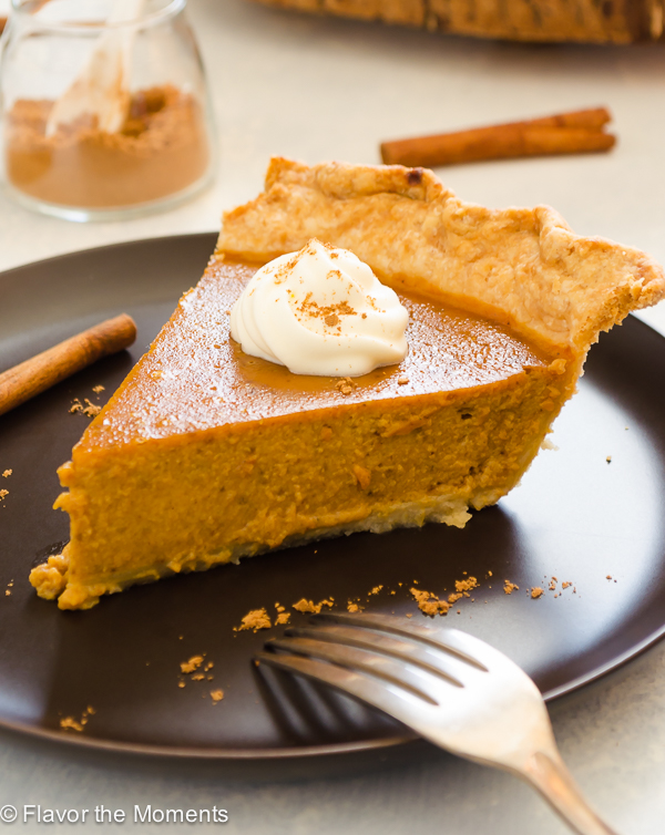Chai Spiced Pumpkin Pie topped with whipped cream and chai spice