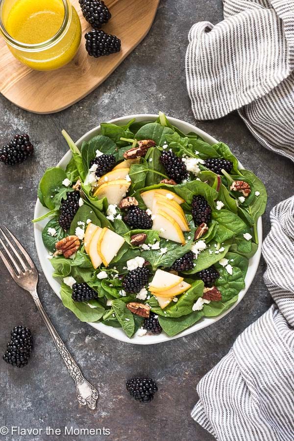 power greens salad on white plate with fork