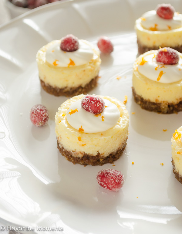 mini cranberry orange cheesecakes on white pedestal server