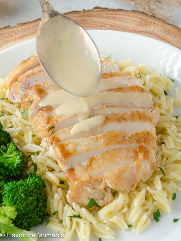 Greek avgolemono sauce drizzled over sliced chicken