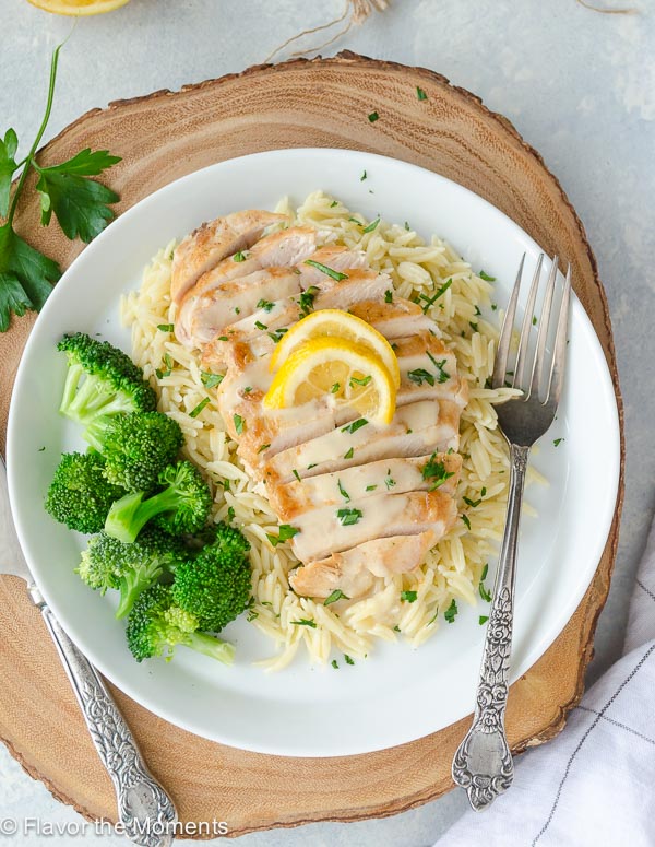 overhead shot of avgolemono chicken sliced over orzo