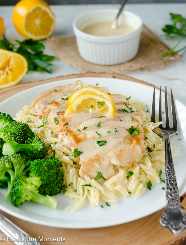 chicken with Greek avgolemono sauce over orzo topped with lemon
