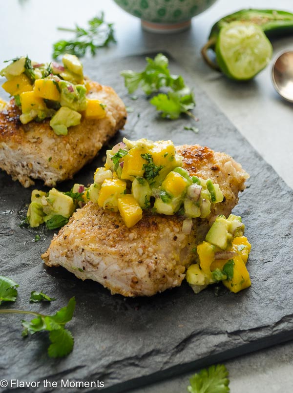 Macadamia Crusted Mahi Mahi with Mango Avocado Salsa is pan seared macadamia crusted mahi mahi topped with a fresh flavorful mango avocado salsa. It's a delicious dinner that's on the table in 30 minutes! @FlavortheMoment