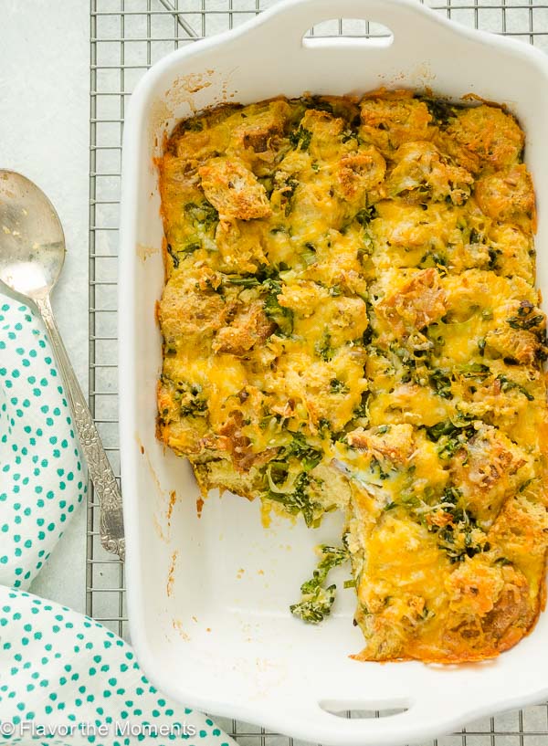 Cheesy broccoli strata in baking dish with serving missing