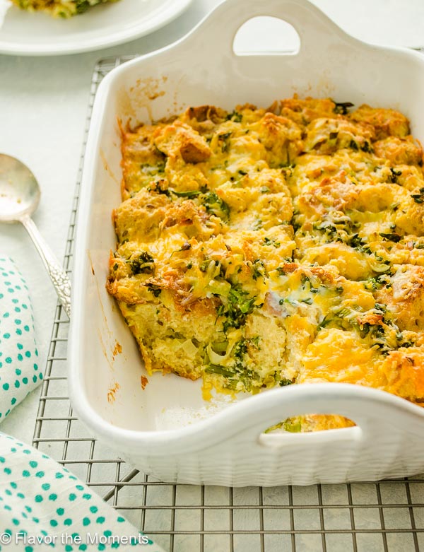 Cheesy broccoli strata in baking dish with serving missing