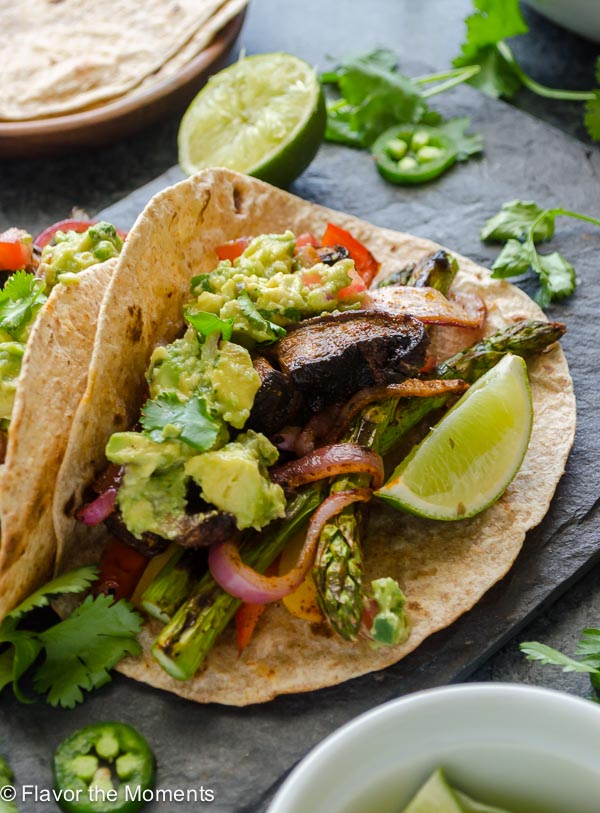 Grilled Portobello Mushroom Asparagus Fajitas are fajita spiced veggies grilled to perfection. Serve with homemade guacamole for a healthy, delicious 30 minute meal! @FlavortheMoment