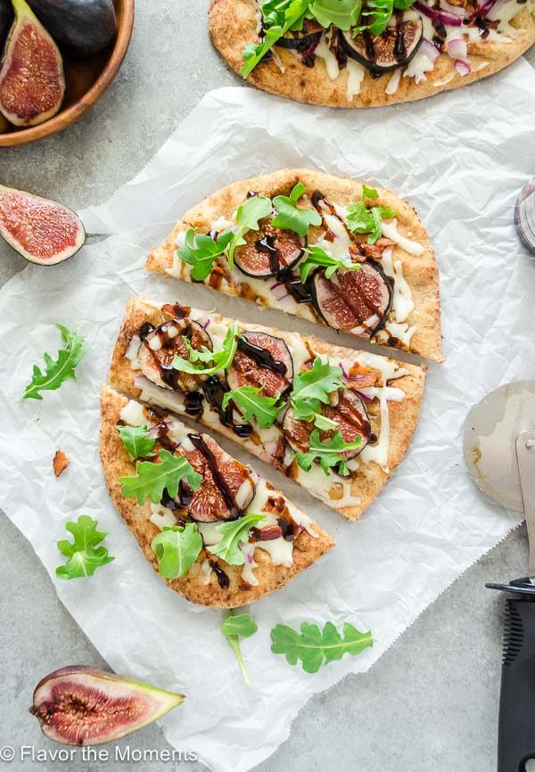 overhead shot of grilled fig pizza sliced on parchment paper