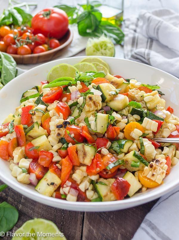 front angled view of grilled corn and zucchini salad in white bowl