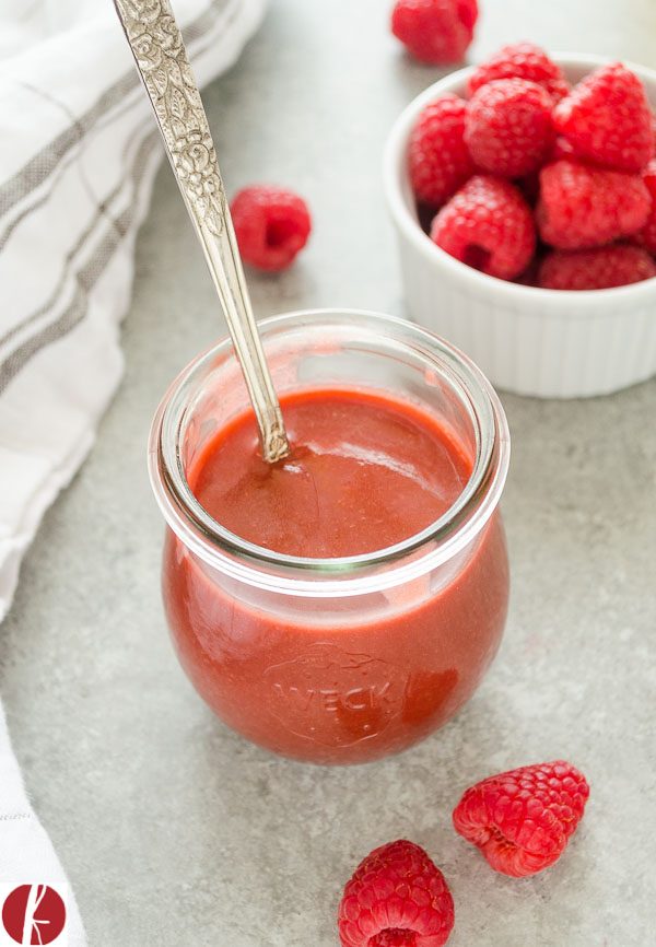 Raspberry balsamic vinegar dressing in a jar with spoon