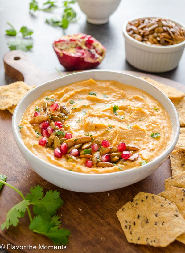 Butternut squash hummus in bowl with pomegranate and pepitas on top