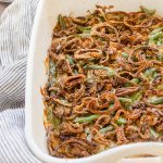 Homemade green bean casserole in baking dish with crispy shallots on top