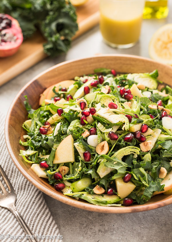 kale and brussels sprout salad in teak bowl