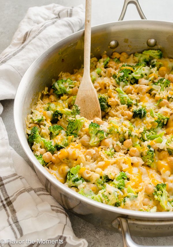 Broccoli rice casserole in skillet with wooden spoon