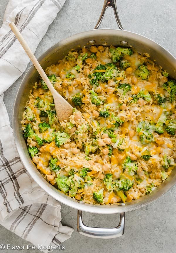 Cheesy Chickpea Broccoli Rice Casserole in skillet with wooden spoon